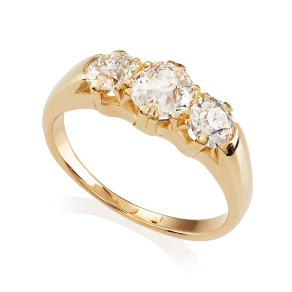 An antique 18ct yellow gold three stone diamond ring, set with old brilliant cut diamonds.