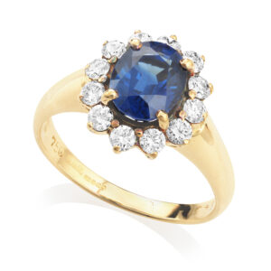 An 18ct yellow gold oval shaped sapphire and round brilliant cut diamond cluster ring.