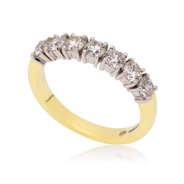 An 18ct yellow gold and platinum round brilliant cut diamond seven stone half eternity ring, with a claw setting.